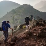 Group of hikers trekking on a rugged mountain trail in Oregon's scenic outdoors.